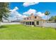 Large grassy backyard with a white fence and rear exterior view of the home at 4221 Kezar Ct, Belle Isle, FL 32812