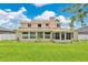 Rear exterior view of the home featuring a large grassy backyard with white privacy fencing at 4221 Kezar Ct, Belle Isle, FL 32812