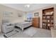 Cozy bedroom with a reading chair, decorative pillows, and a bookshelf, perfect for relaxation at 4221 Kezar Ct, Belle Isle, FL 32812