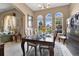 Formal dining room with an archway looking into the living area, featuring a decorative table set for an elegant dinner at 4221 Kezar Ct, Belle Isle, FL 32812