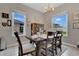 Dining room features natural light, wood floors, a wood table, and a stylish light fixture at 4221 Kezar Ct, Belle Isle, FL 32812