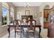 Formal dining room with an elegant table setting, complemented by natural light from large windows and stylish decor at 4221 Kezar Ct, Belle Isle, FL 32812