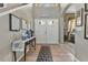 Elegant foyer with tile flooring, a decorative table, and a view into the living spaces, creating a grand entrance at 4221 Kezar Ct, Belle Isle, FL 32812