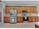Kitchen boasting wooden cabinetry, stainless steel appliances, and neutral countertops at 4221 Kezar Ct, Belle Isle, FL 32812