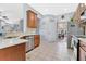 Well-lit kitchen features tile flooring, stainless steel appliances, and views into the dining room at 4221 Kezar Ct, Belle Isle, FL 32812