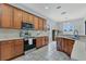 Bright kitchen features modern appliances, wooden cabinets, and granite countertops at 4221 Kezar Ct, Belle Isle, FL 32812