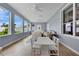 Bright living room with large windows, hardwood floors, and white seating area at 4221 Kezar Ct, Belle Isle, FL 32812