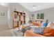 Inviting living room with leather sofas, a ceiling fan, and decorative shelving unit at 4221 Kezar Ct, Belle Isle, FL 32812