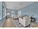 Bright living room with hardwood floors, white seating area, and large windows at 4221 Kezar Ct, Belle Isle, FL 32812