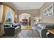 Comfortable living room featuring plush sofas, a decorative rug, and an archway leading to the adjacent dining area at 4221 Kezar Ct, Belle Isle, FL 32812