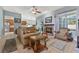 Inviting living room with a cozy fireplace, comfortable seating, and an open layout connecting to the kitchen area at 4221 Kezar Ct, Belle Isle, FL 32812