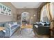 Cozy living room with stylish seating, a decorative rug, and an archway offering a glimpse into the inviting foyer at 4221 Kezar Ct, Belle Isle, FL 32812