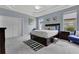 Spacious main bedroom with tray ceilings, soft carpet, and bright natural lighting at 4221 Kezar Ct, Belle Isle, FL 32812