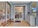 Bright sunroom with sliding door with views of the dining room and an accent cabinet with a coffee station at 4221 Kezar Ct, Belle Isle, FL 32812