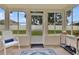 The bright sunroom has neutral walls, wood floors and windows overlooking the backyard at 4221 Kezar Ct, Belle Isle, FL 32812