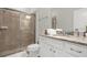 This bathroom features a walk-in shower with glass door and vanity with granite counters at 4310 Lana Ave, Davenport, FL 33897