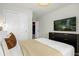 Bright bedroom featuring a bed with a modern headboard, mounted TV, and double closets at 4310 Lana Ave, Davenport, FL 33897