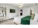 Stylish bedroom features a mounted TV, white dresser, and contemporary decor at 4310 Lana Ave, Davenport, FL 33897