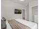 Bright bedroom featuring a TV, closet, and a neatly made bed at 4310 Lana Ave, Davenport, FL 33897