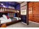 Charming bedroom with unique bunk bed design and whimsical plaid wallpaper at 4310 Lana Ave, Davenport, FL 33897