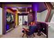 Modern game room features neon lights, tv, comfortable seating and is the perfect entertainment space at 4310 Lana Ave, Davenport, FL 33897