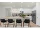 Modern kitchen featuring white cabinets, granite countertops, stainless steel appliances, and island seating at 4310 Lana Ave, Davenport, FL 33897