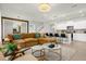 Inviting living room with plush sofa, stylish decor, and seamless flow to the modern kitchen at 4310 Lana Ave, Davenport, FL 33897