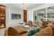 This living room features modern furnishings, a large-screen TV, and sliding glass doors leading to the outdoors at 4310 Lana Ave, Davenport, FL 33897