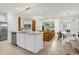 Open-concept living space with a kitchen island, dining area, and comfortable seating at 4310 Lana Ave, Davenport, FL 33897