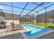 The backyard features a screened-in pool with lounge chairs and a BBQ grill at 4310 Lana Ave, Davenport, FL 33897