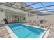 This inviting backyard features a swimming pool, lounge chairs, BBQ grill, and a covered patio at 4310 Lana Ave, Davenport, FL 33897