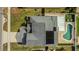 Aerial view of the property showing the pool, solar panels, and the brick paver patio at 485 Whittingham Pl, Lake Mary, FL 32746