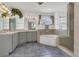 Bright bathroom features a soaking tub, walk-in shower, dual vanities, and blue tile floors at 485 Whittingham Pl, Lake Mary, FL 32746