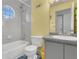 Cozy bathroom features a tiled shower-tub, toilet, and a gray vanity with a sink at 485 Whittingham Pl, Lake Mary, FL 32746