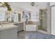 Well-lit bathroom features a soaking tub, walk-in shower, dual vanities, and blue tile floors at 485 Whittingham Pl, Lake Mary, FL 32746