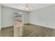 Bright bedroom features wood-look floors, a ceiling fan, and sliding glass doors leading to the backyard at 485 Whittingham Pl, Lake Mary, FL 32746