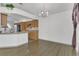 Open-concept dining area next to the kitchen, featuring hardwood floors and modern lighting at 485 Whittingham Pl, Lake Mary, FL 32746