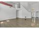 Bright living room boasts soaring ceilings, wood-look floors, and a staircase leading to the second floor at 485 Whittingham Pl, Lake Mary, FL 32746
