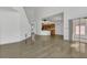 Open-concept living room showcases wood-look floors, vaulted ceilings, and seamless flow to kitchen and patio at 485 Whittingham Pl, Lake Mary, FL 32746
