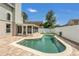 Backyard pool with brick patio, white fence, and a screened-in porch on the house at 485 Whittingham Pl, Lake Mary, FL 32746