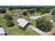 Aerial view of a home showcasing a private driveway, detached garage, and landscaping at 4895 Cr 134B, Wildwood, FL 34785