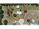 Expansive property featuring a house and additional structure surrounded by lush greenery and circular drive at 4895 Cr 134B, Wildwood, FL 34785