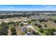 Wide aerial view showcasing a community of houses in green landscape, with open development plots for future construction at 4895 Cr 134B, Wildwood, FL 34785