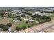 Wide aerial shot showcasing multiple residences surrounded by trees in a neighborhood with community amenities at 4895 Cr 134B, Wildwood, FL 34785