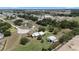 Aerial view of a charming home with a metal roof, a detached garage, and lush greenery in a quiet location at 4895 Cr 134B, Wildwood, FL 34785