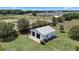 Aerial shot of the detached garage nestled among trees and landscaping in a serene environment at 4895 Cr 134B, Wildwood, FL 34785