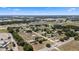 Aerial view of a quiet, rural community with spacious lots, mature trees, and well-maintained homes under a clear blue sky at 4895 Cr 134B, Wildwood, FL 34785