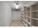 A bright storage room or basement area with block wall and built-in shelving at 4895 Cr 134B, Wildwood, FL 34785