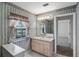 Bathroom with vanity and mirror at 4895 Cr 134B, Wildwood, FL 34785