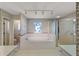 Bathroom featuring a shower, bathtub, vanity, and decorated wallpaper at 4895 Cr 134B, Wildwood, FL 34785